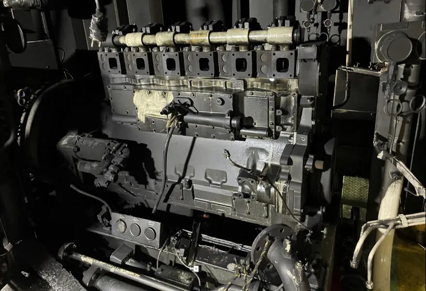 Soot-covered auxiliary diesel generator in the port engine room of Scot Stuttgart after the fire